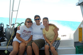three friends enjoying the boat ride back in from the dive